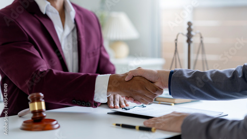 Businessman handshake to seal a deal with his partner lawyers or attorneys discussing a contract agreement. photo