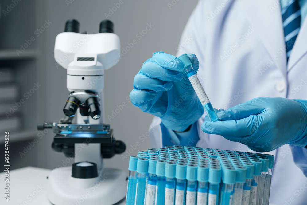 Scientists conducting research investigations in a medical laboratory. Scientist wearing medical gloves nanotechnology, research, fiber, microbiology, glass, test tube, medicine - obrazy, fototapety, plakaty 