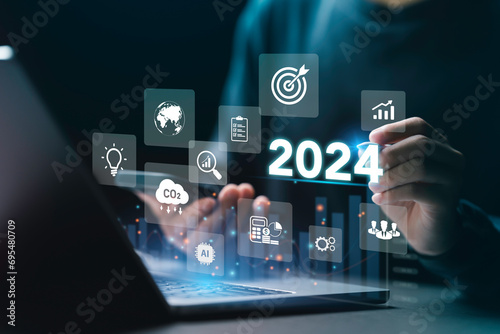 Businessman plan strategy marketing and finance to goal in 2024 planning business growth with technology AI and environmental care to New Year resolutions business. digital transformation 2024 photo