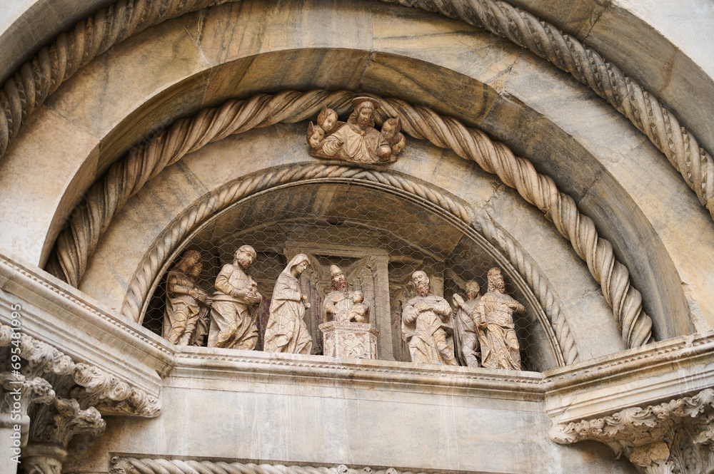 Exterior of the Cathedral in Como city, with Italian architectural details, sculpture, stone carvings. Lombardy. Italy