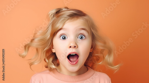 Cute little girl surprised face looking at camera