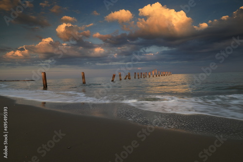 Inclined Column Beach, scenery view of the concrete columns from the old port with beautiful sky on Sao Iang Beach at Phetchaburi province,Thailand  photo