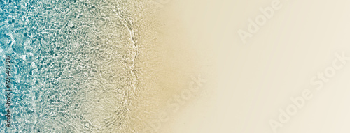 abstract turquoise water wave with sunlight on white sand beach from above, empty summer vacation background banner with copy space for travel and natural beauty spa