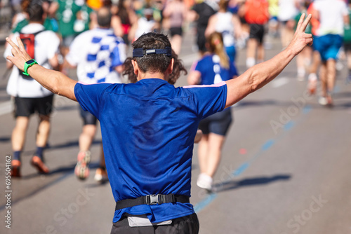 Runners on the street. Healthy lifestyle. Jogging exercise. Victory sign