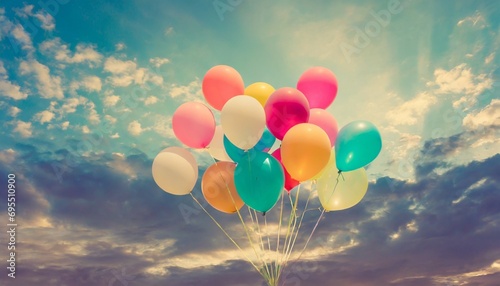 colorful balloons flying on sky with a retro vintage filter effect the concept of happy birthday in summer and wedding honeymoon party usage for background vintage color tone