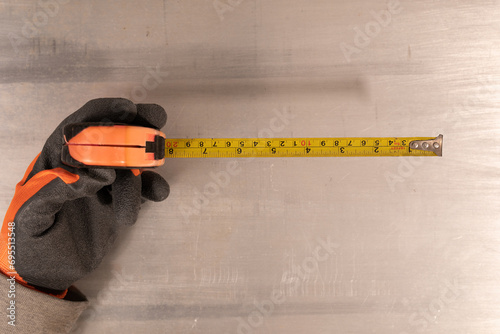 Gloved hand holding a measu...