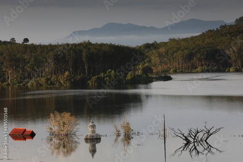 Sinking Buddha statue (Drowning Buddha) and reflection.A large Buddha statue in the middle of the lake. Phre Phutta Siri Phuwadon Mongkolchai.
Khao Ra-Kham reservoir, Trat province,Thailand. photo