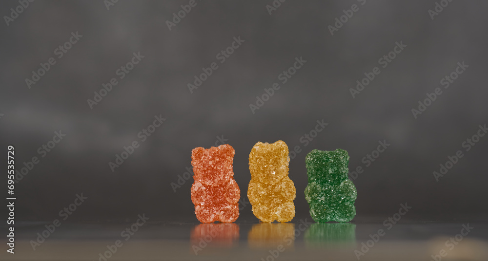 detail of colorful sugar candies in the shape of bears with an out of focus background detail of colorful sugar candies in the shape of bears with an out of focus background