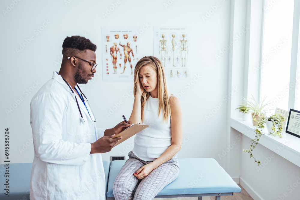 Fototapeta premium Doctor and patient discussing something at hospital . Medicine and health care concept. Doctor and patient. Patient Having Consultation With Doctor In Office.