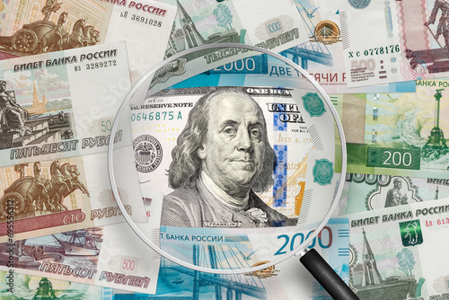 American dollar  and Russian ruble banknotes. View through magnifying glass photo