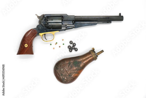 Black powder percussion revolver Remington 1858 New Army and the equipment such as a gunpowder flask, lead balls and percussion caps on a white background. Right side.