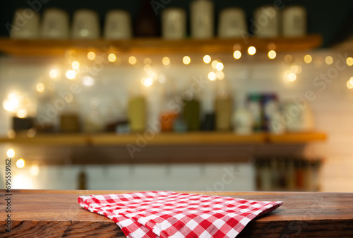 Empty wooden deck table and red checked tablecloth over mint wallpaper background. High quality photo photo