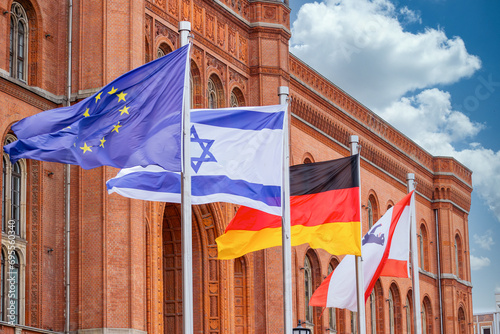 Photography The European, Israeli, German and Berlin flags blow in the wind in front of the