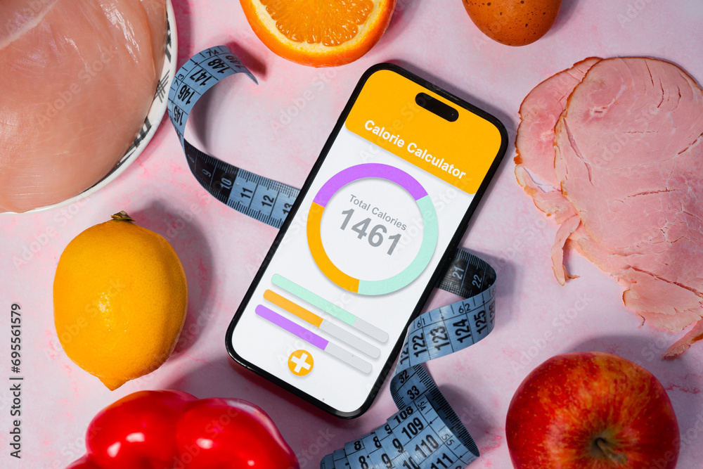 An application for counting calories next to healthy eating. Calorie deficit and weight loss. Maintaining a healthy and balanced diet - obrazy, fototapety, plakaty 