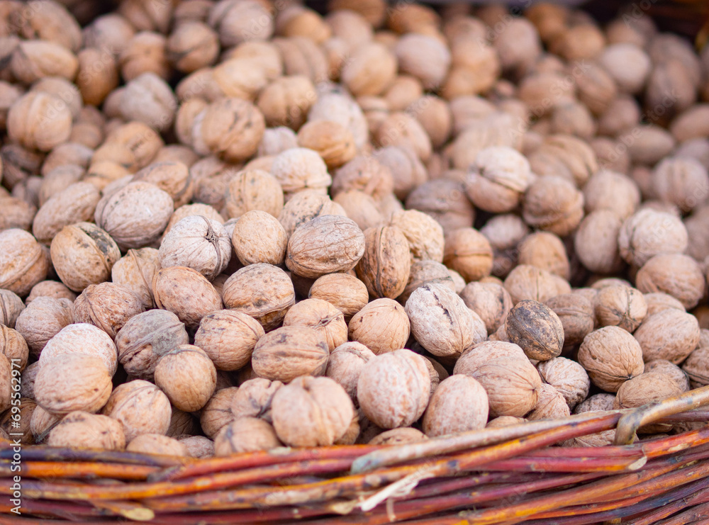 huge wicker basket with walnuts. harvest concept. walnut, close-up. huge wicker basket with walnuts. harvest concept. walnut, close-up.