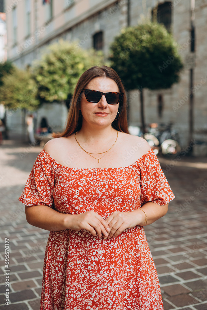 Fototapeta premium Portrait beautiful woman in sunglasses in street. Happy tourist travels in Europe. Vacation concept by exploring interesting places to travel. Lifestyle tourist travel holiday banner