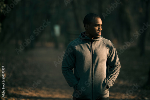 Male athlete doing stretching exercises in a park