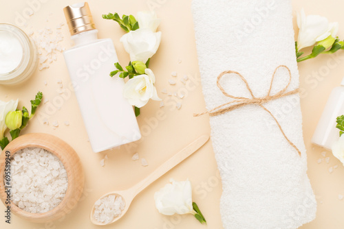 Flat lay with spa products and flowers on color background