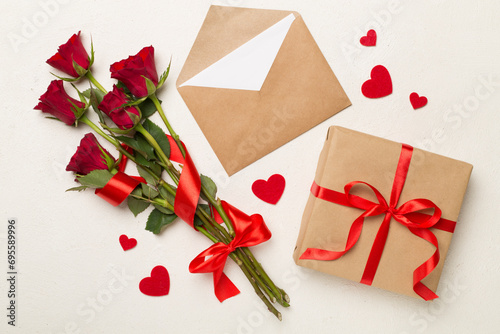 Red rose flowers with gift box on concrete background, top, view. Valentine's day concept