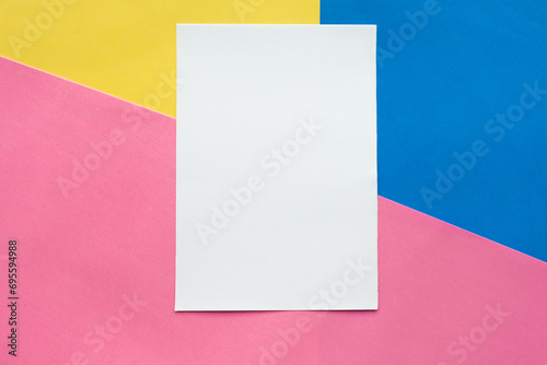 White mockup blank on blue, yellow and pink paper background