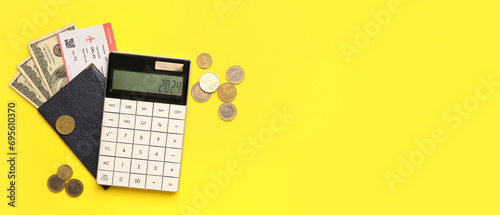 Calculator with passport, ticket and money on yellow background with space for text
