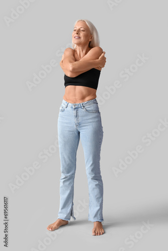 Body positive mature woman on light background