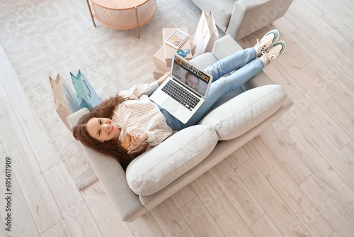 Young woman with laptop and...