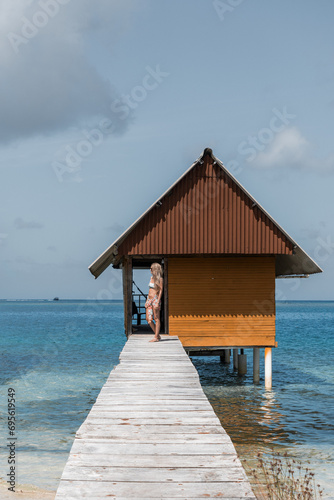 Woman in a cabin at a bridge overlooking the sea