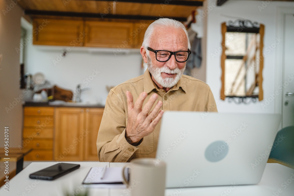 Fototapeta premium Senior caucasian man use laptop computer to make a video call at home