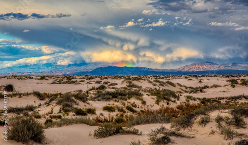 Storm and rainbow in the distance at White Sands New Mexico