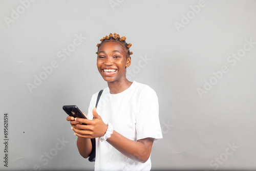 pretty excited young black lady feeling excited while viewing content on her smartphone © Vic Josh