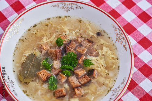Close up picture of strong and healthy garlic soup, significant example of the dish from cuisine of Czech republic. Soup is made from broth, poatoes, garlic and mashed eggs, parsley and bread crumbs.