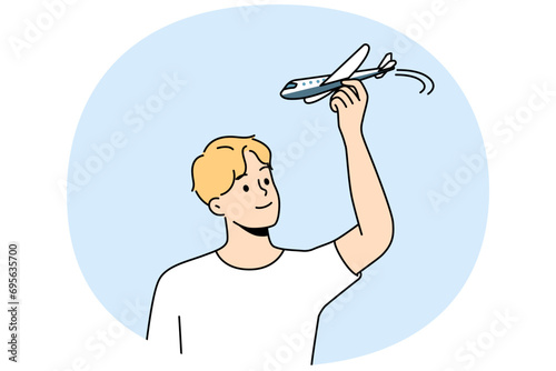 Young man have fun playing with airplane model. Smiling guy flying with plane miniature. Aviation and hobby. Vector illustration.