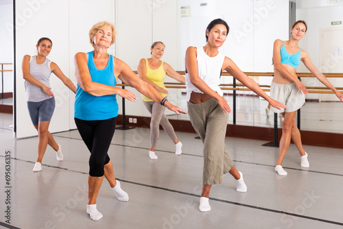 Modern positive active females dancing excited posing in studio