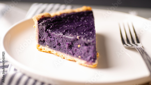 Purple yam pie on a white ceramic plate. photo