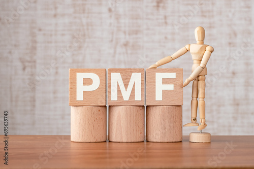 There is wood cube with the word PMF. It is an abbreviation for Product Market Fit as eye-catching image.