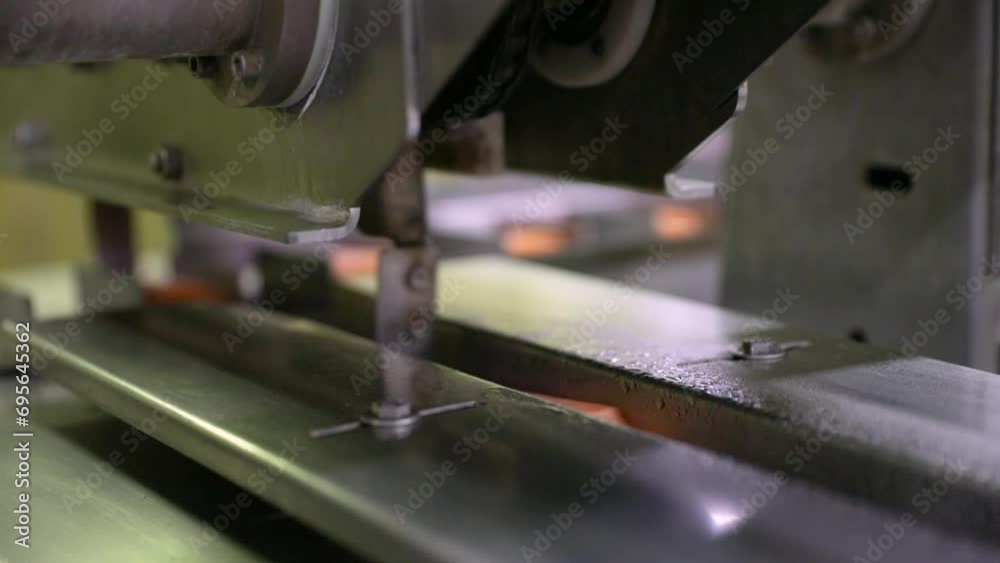 Food industry. Automation and technology in food production. Commercial strawberry and orange flavored popsicles machine, transporting the product. Food industry. Automation and technology in food production. Commercial strawberry and orange flavored popsicles machine, transporting the product.
