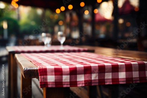 Outdoor restaurant table with checkered tablecloth photo