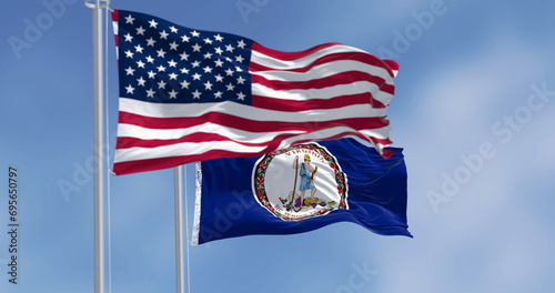 Virginia state flag waving with the american flag on a clear day photo