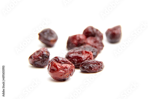 Dried and sweetened cranberries isolated on white background, top view. Heap of scattered cranberries closeup