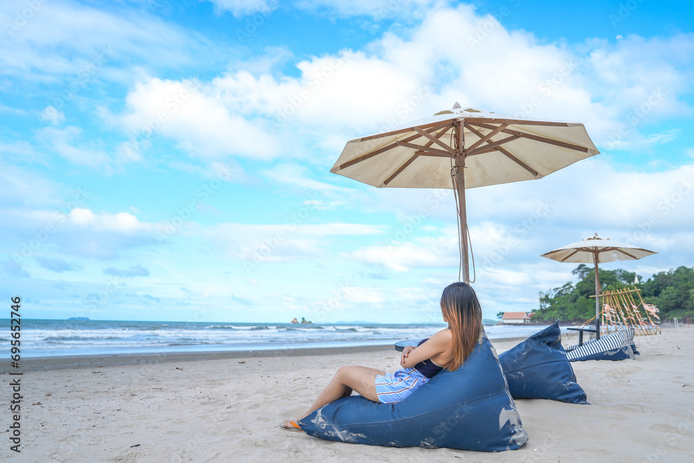 Portrait beautiful young asian woman relax smile leisure on sofa bed beach sea ocean with blue sky white cloud Portrait beautiful young asian woman relax smile leisure on sofa bed beach sea ocean with blue sky white cloud