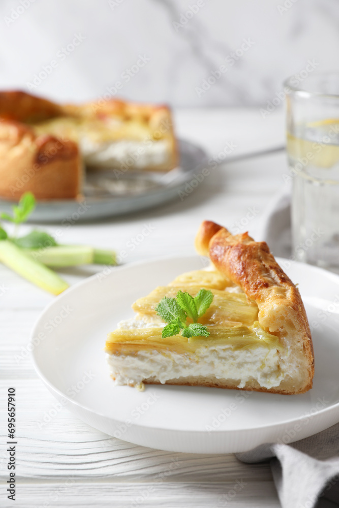 Freshly baked rhubarb pie with cream cheese, stalks and mint leaves on white wooden table, closeup Freshly baked rhubarb pie with cream cheese, stalks and mint leaves on white wooden table, closeup