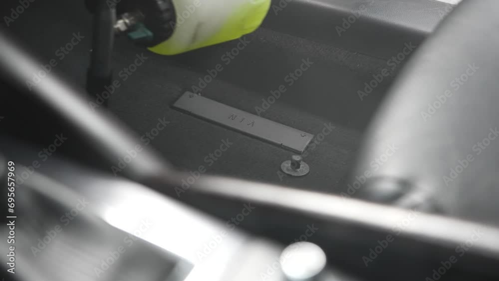 A man does professional dry cleaning of a car interior. high pressure air pulse cleaning gun. A man does professional dry cleaning of a car interior. high pressure air pulse cleaning gun.