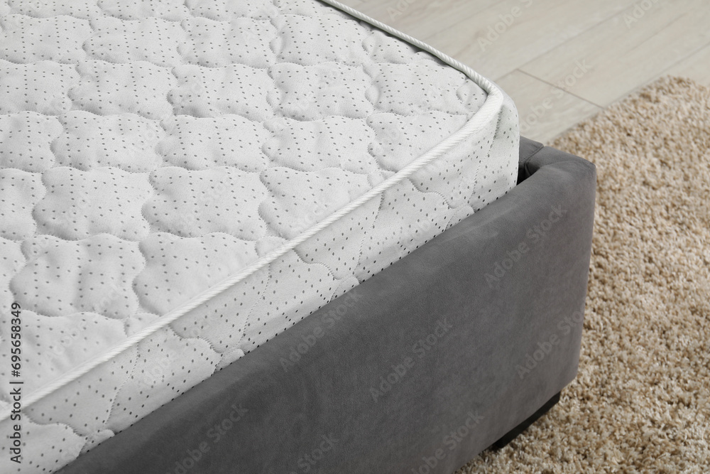 Comfortable bed with new soft mattress indoors, closeup Comfortable bed with new soft mattress indoors, closeup