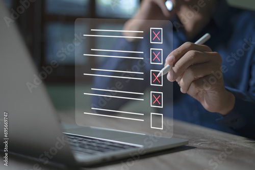 Smart checklist concept on virtual screen A man uses a marker to explore topics in a digital form review document.