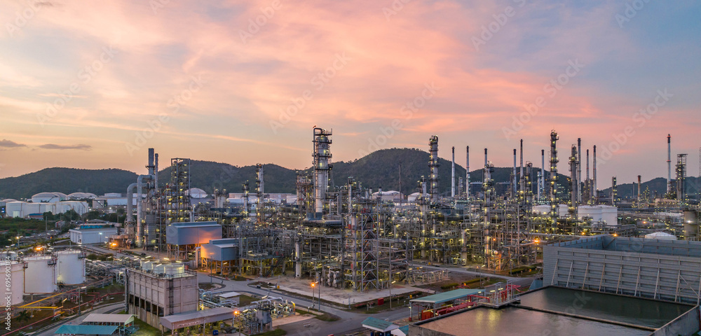 Oil and gas industrial refinery at twilight, Oil refinery and Petrochemical plant pipeline steel, Refinery factory oil storage tank and pipeline steel at night.