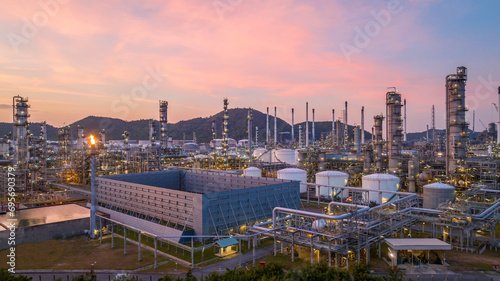 Oil and gas industrial refinery at twilight, Oil refinery and Petrochemical plant pipeline steel, Refinery factory oil storage tank and pipeline steel at night.