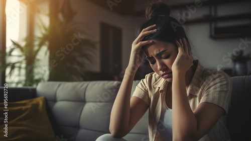 girl headache or migraine pain suffering from vertigo while sitting at home photo