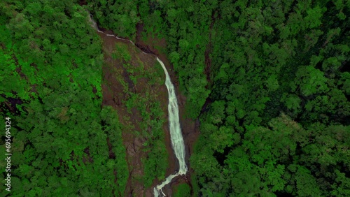 Aerial unveiling view of Bijagual waterfall cascade in remote Costa Rica photo