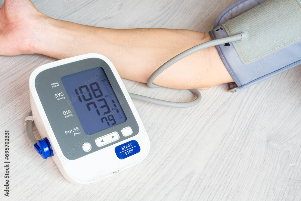 Man check blood pressure monitor and heart rate monitor with digital pressure gauge. Health care and Medical concept
Man check blood pressure monitor and heart rate monitor with digital pressure gauge. Health care and Medical concept